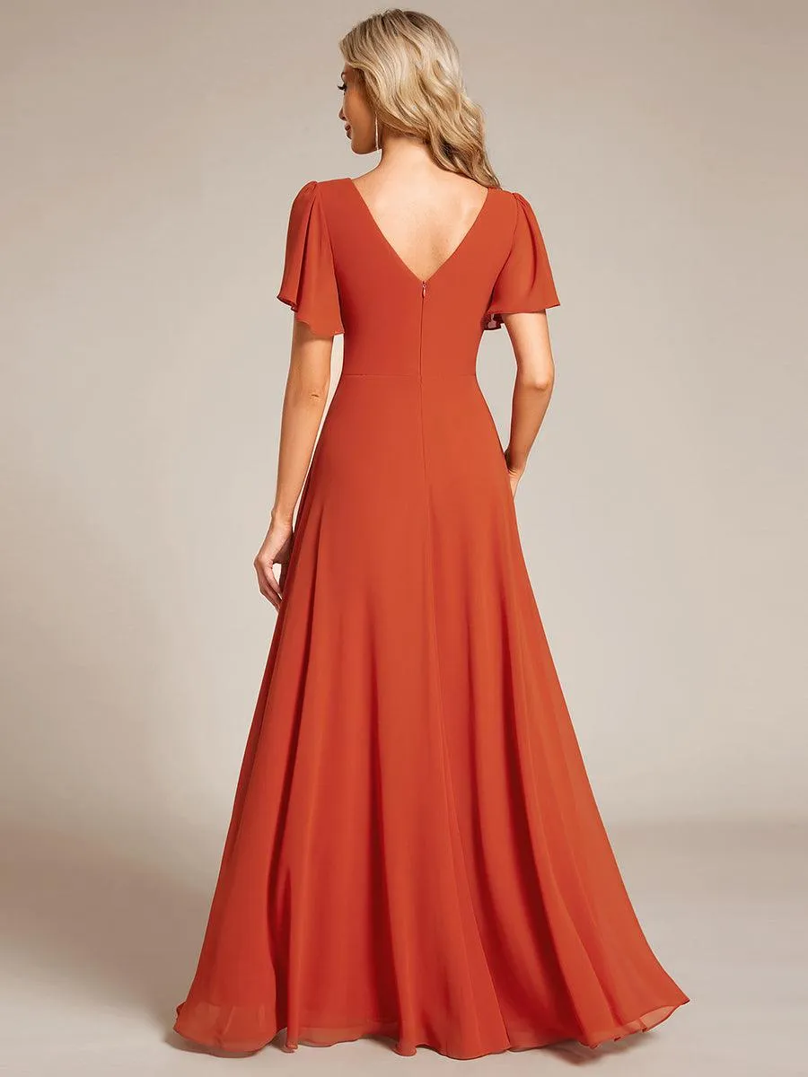 Robe de soirée plissée trapèze en mousseline de soie manches courtes et taille à sequins