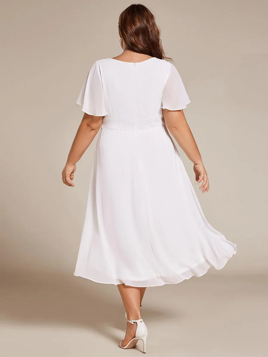 Robe d'invité de mariage trapèze en mousseline fluide à encolure ronde et longueur au genou