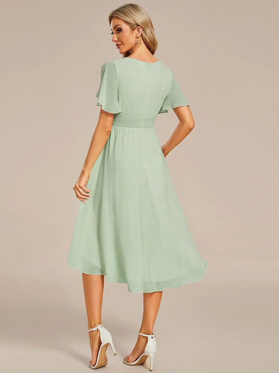 Robe d'invité de mariage trapèze en mousseline fluide à encolure ronde et longueur au genou